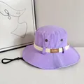 Close-up of purple nylon sun hat with leather logo patch and adjustable windproof cord - M / Purple