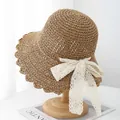 Handwoven straw sun hat for women featuring wavy brim and elegant lace ribbon bow tie - M (56-58cm) / Khaki