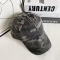Detail of washed camouflage baseball cap texture on a stack of decorative books - M (56-58cm) / Black Grey Camouflage