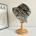 Vintage washed camouflage bucket hat for outdoor hiking on a wooden display stand - M (56-58cm) / Bionic Tree Camouflage