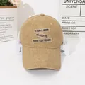 Detailed close-up of khaki washed cotton baseball cap with vintage embroidered patches - M (56-58cm) / Khaki