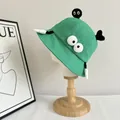 Detail of green cartoon bucket hat featuring big eyes and unique decorative accents - M (56-58cm) / Green