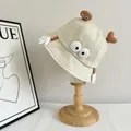 Detail of beige canvas bucket hat with 3D cartoon eyes and a small brown plush toy - M / Beige