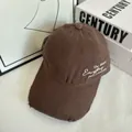 Detail of distressed brown baseball cap featuring side embroidery and vintage torn texture - M / Coffee