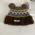 Detailed view of the cute bear ears and multi-color jacquard pattern on the winter hat - M / Coffee