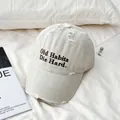 Detail of vintage baseball cap with embroidery text and distressed ripped cotton canvas - M(56-58cm) / Beige