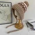 Detailed knit pattern of Fair Isle winter earflap hat with fluffy pom-poms and braids - M (56-58cm) / Khaki