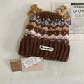 Close-up of Fair Isle knit hat featuring decorative plush antlers and snowflake patterns - M (56-58cm) / Coffee