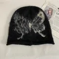Close-up of a black knit beanie with butterfly pattern and soft mohair texture - M (56-58cm) / Black