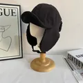 Detail of warm black trapper hat with soft faux shearling lining and adjustable chin strap - M(56-58cm) / Black