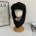 Detail of black faux shearling trapper hat with earflaps on a white mannequin head - M / Black