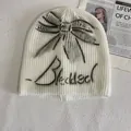 White ribbed knit beanie with black graffiti bow and Blessed text on cream background - M (56-58cm) / White
