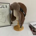 Detailed close-up of a brown winter aviator hat with thick faux fur lining and buckle - M (56-58cm) / Camel