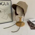 Detail of khaki leather trapper hat featuring leopard print plush lining and side ties - M(56-58cm) / Khaki