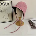 Pink tweed aviator hat with herringbone pattern and long ties on a white mannequin head - M (56-58cm) / Pink