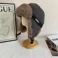 Close-up of gray windproof winter aviator hat with plush brown faux fur lining and buckle - M (56-58cm) / Gray