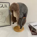 Detail of winter trapper hat with suede fabric, plush lining, and star patch detail - M (56-58cm) / Gray