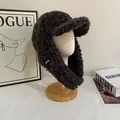Detail of dark brown plush trapper hat with soft faux fur and warm ear flaps for winter - M(56-58cm) / Black