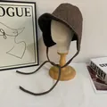 Close-up of deep brown herringbone wool trapper hat with long earflap straps - M (56-58cm) / Coffee