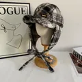Detailed view of plaid trapper hat with fur-like texture and Noandho leather patch - M(56-58cm) / Black & White Check