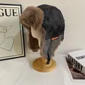 Detail of dark grey trapper hat with warm brown faux fur lining and orange stitching - M (56-58cm) / Black