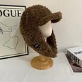 Detailed view of the dark brown plush faux shearling aviator hat with earflaps on a stand - M(56-58cm) / Coffee
