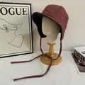 Close-up of wine red herringbone earflap hat with thick lining and braided straps - M (56-58cm) / Brick Red