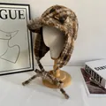 Detail showing plush leopard print trapper hat with warm earflaps and leather logo label - M(56-58cm) / Leopard Print Patchwork