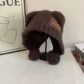 Detailed view of plush teddy fabric and bear ear design on a warm winter hat with pom-poms - M (56-58cm) / Coffee