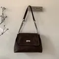 Detail of vintage dark brown leather shoulder bag with silver chain and metal buckle - Brown