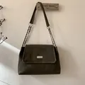 Detail of dark olive green matte shoulder bag with silver metal plate and chain strap - Green