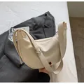 Close-up of cream crescent shoulder bag with adjustable strap and textured leather finish - Off-White Without Charm