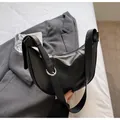 Detail view of the black crescent hobo bag with leather texture and silver buckle detail - Black without Pendant