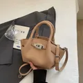 Minimalist apricot bucket bag with litchi grain leather and silver twist lock - Khaki Without Charm