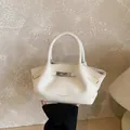 Elegant cream white bucket bag with pebble leather texture and silver metal lock detail - No Pendant / White