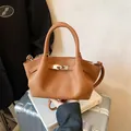 Brown lychee leather bucket bag with silver metal buckle and top handle strap - No Pendant / Brown