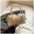 Detail of lychee textured leather boston bag in creamy white with silver zippers - Without Pendant / Off White