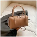Detailed macro view of pebble grain leather texture and metallic zippers on apricot bag - Without Pendant / Pink