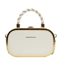 Detail of elegant cream-white box clutch with gold metal frame and twisted handle design - White
