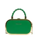 Close-up of vibrant green hard shell box bag with gold metal frame and twisted handle - Green
