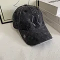 Macro view of distressed black denim baseball cap with embroidered geometric logo details - M (56-58cm) / Black