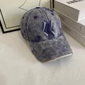 Detailed macro of vintage denim baseball cap with embroidery and distressed stitching - M (56-58cm) / Blue