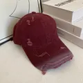 Detailed macro view of distressed holes and raw edges on a vintage burgundy baseball cap - M (56-58cm) / Burgundy