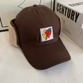 Detailed close-up of brown winter baseball cap with lamb wool earflaps and embroidery - M(56-58cm) / Coffee