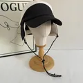 Detail of color-block winter trapper hat featuring fleece ear flaps and windproof drawstrings - M (56-58cm) / White