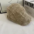 Detailopname van een licht camel corduroy platte pet op een tafel met vintage decor - M(56-58cm) / Khaki