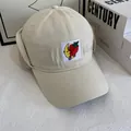 Close-up of beige winter baseball cap featuring plush ear flaps and strawberry embroidery - M(56-58cm) / White