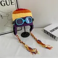 Detail of colorful knit aviator beanie with blue goggles and braided tassels - M / Colorful