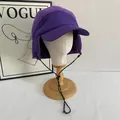 Purple fleece earflap hat with polka dot drawstrings on a white display head stand - M (56-58cm) / Purple