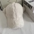 Close-up of white lamb wool baseball cap with cute pom-pom ears on a textured table - M (56-58cm) / White